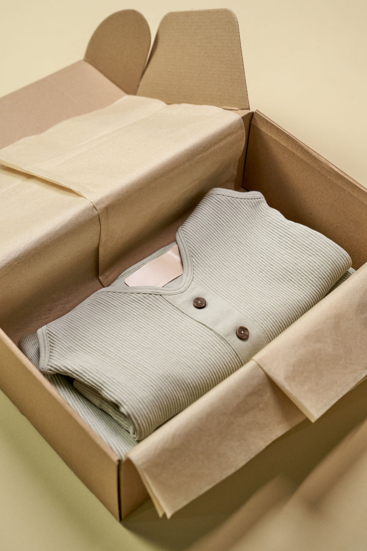 Folded knit apparel in a cardboard packaging box